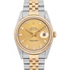 An image of a pre-owned men's Rolex wristwatch, viewed from a front angle at a close distance. The watch features a gold and steel metal band with a gold bezel. The face is gold-toned with diamond hour markers and includes a date indicator at the 3 o'clock position. The brand name "Rolex" and model "Oyster Perpetual Datejust" are visible on the watch face.