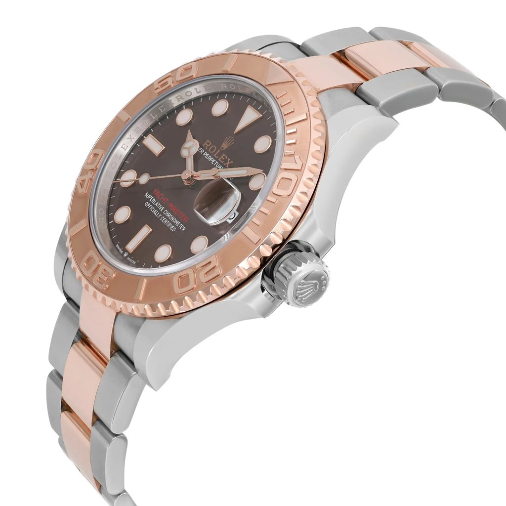 An image of a pre-owned wristwatch displayed from a side profile view, emphasizing the crown. The watch features a two-tone metal bracelet and a bezel with engraved numerals. The watch face shows a dark dial with prominent hour markers and hands. The angle highlights the crown and part of the bracelet, with a slight upward perspective.