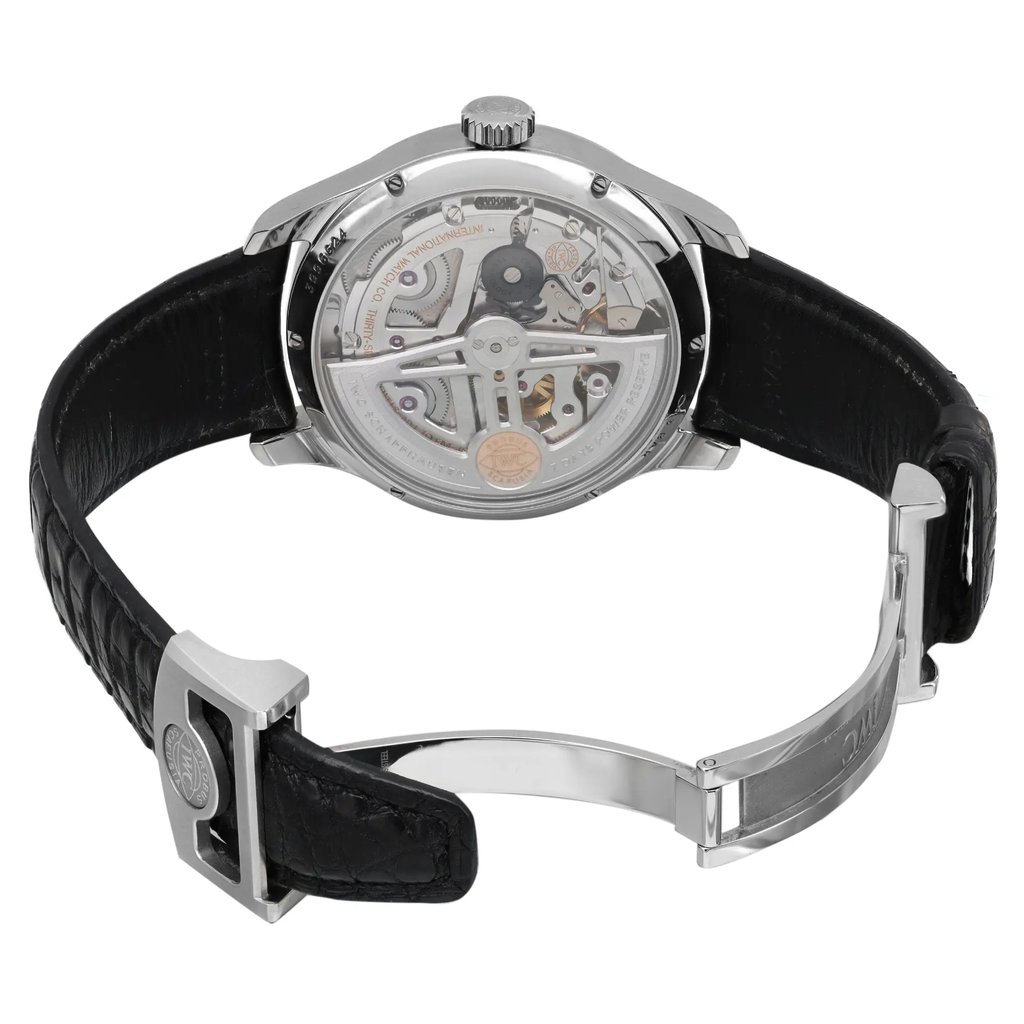An image of a pre-owned wristwatch shown from the back view with an open clasp. The watch is positioned upright, showcasing its intricate mechanical movement. The angle highlights the transparent case back, allowing a clear view of the internal components. The leather strap is visible, with the clasp open and extended towards the foreground. The image is taken at a close range to emphasize the watch's details and craftsmanship.