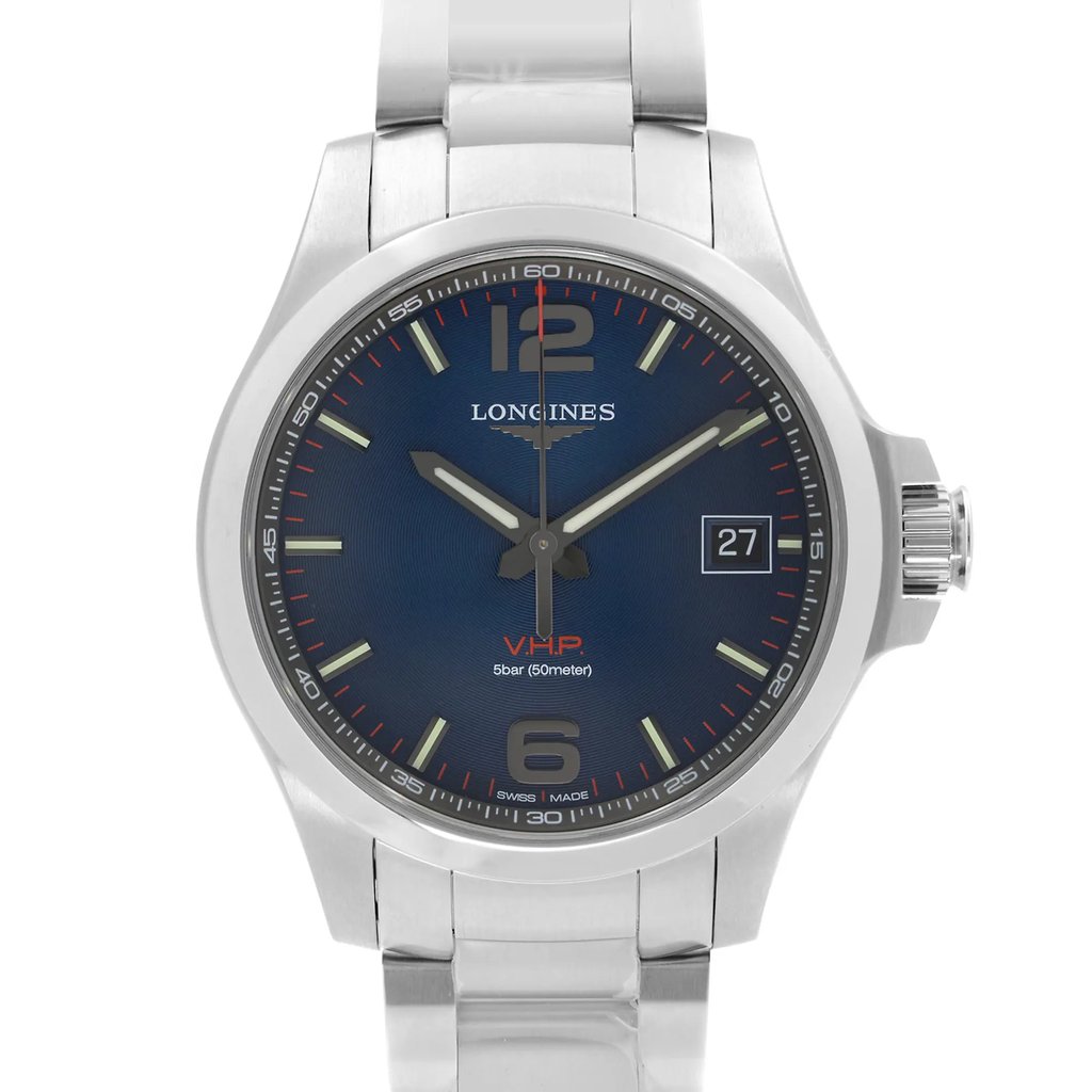 An image of a wristwatch taken from a front close-up angle, showcasing the watch face. The display model features a sleek design with a blue dial, silver hour markers, and a date window at the 3 o'clock position. The watch has a polished metal case and a matching band, with the brand name visible beneath the 12 o'clock marker.