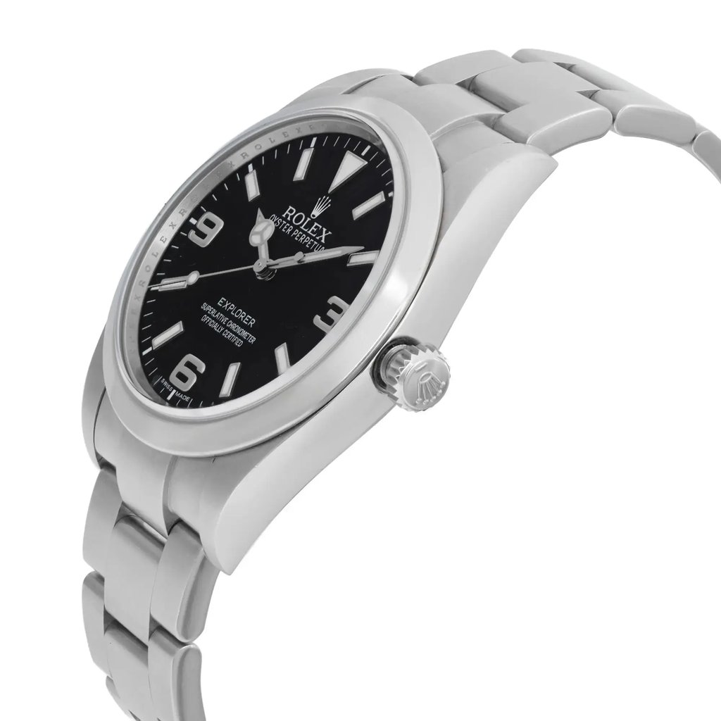 An image of a pre-owned wristwatch shown from a side profile view. The watch's crown is prominently displayed, positioned on the right side of the image. The angle highlights the sleek design of the case and bracelet, with the face slightly tilted upwards. The distance captures a detailed view of the watch's features and logo on the crown.