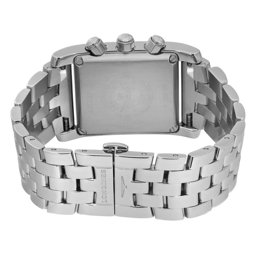 An image of a pre-owned wristwatch taken from the back view, showcasing the clasp in a closed position. The angle highlights the metallic bracelet and the back of the watch case, revealing intricate details and engravings. The photograph is taken at a close distance, focusing on the brand name engraved on the clasp and the surrounding links.