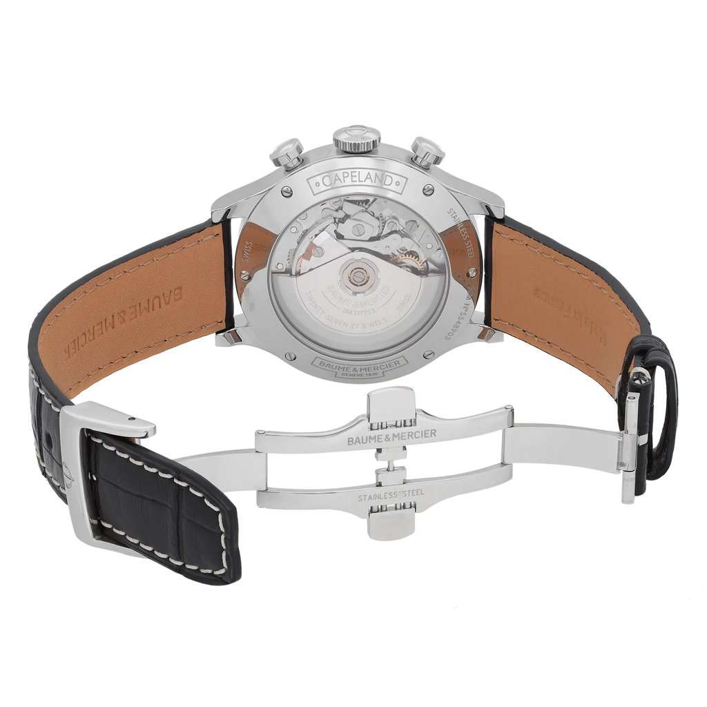 An image of a wristwatch showcasing the back view with an open clasp. The watch is positioned upright, revealing the intricate mechanical movement through the transparent case back. The image is taken from a close angle, highlighting the brand engraving on the leather strap and clasp. The condition is pristine, indicative of a display model.