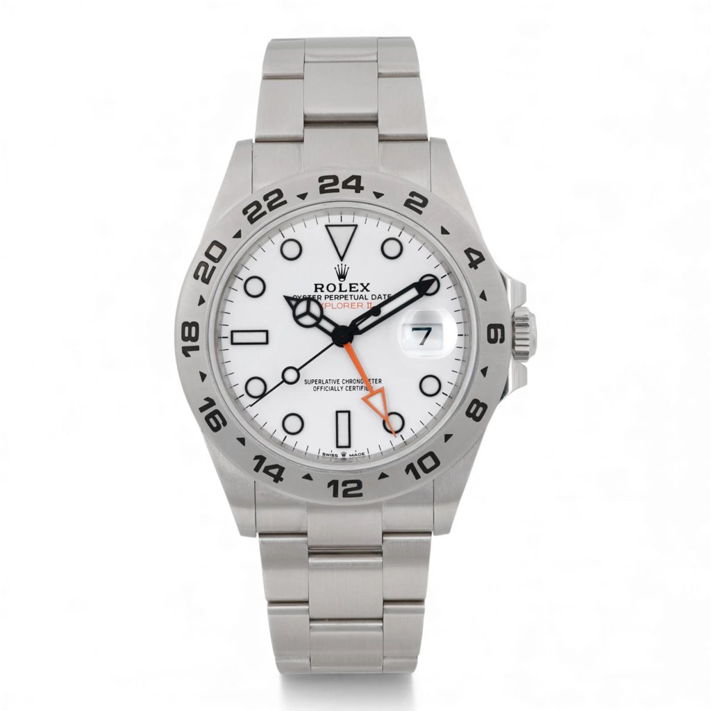 An image of a pre-owned men's Rolex Explorer II GMT 42mm Steel White Dial Automatic Oyster wristwatch taken from a front-facing angle. The watch features a stainless steel band and a white dial with black hour markers and hands, including luminous hands for visibility. The date indicator is visible at the three o'clock position, and the watch also displays a distinctive orange hand. The image is captured at a close distance, highlighting the watch's details and craftsmanship. Pre-owned in excellent condition. Full links. 2022 card. Original box and papers. It shows light signs of wear.

