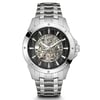 An image of a pre-owned Bulova men's wristwatch with a skeleton dial that allows a view of the internal mechanical parts. The watch is centered and shown from a front view at a close distance, with the face of the watch taking up most of the frame. It features luminous hands, a silver-tone metal bracelet, and a round bezel with small screw details. The Bulova logo is prominently displayed on the upper half of the watch face.