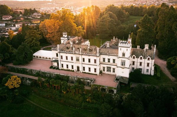 Castello Dal Pozzo — neo-Gothic castle towers rising above its 24-hectare park in the hills over Lake Maggiore