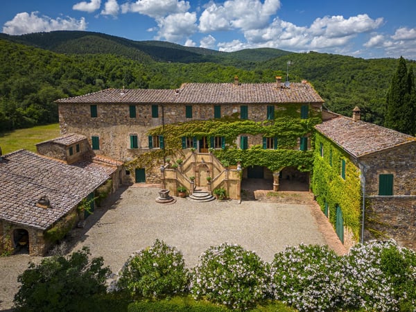 Borgo di Recenza — ivy-covered stone borgo in the Sienese hills, a classic Tuscan wedding estate seen from above