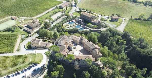 Castel Monastero — 11th-century Tuscan hamlet turned five-star resort near Siena, with its medieval piazza celebration square