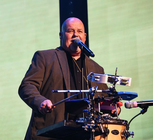 Rob Wilson singing at his percussion setup