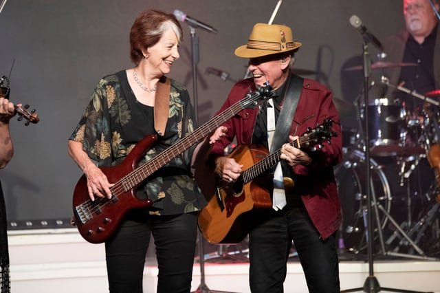 Dean and Sheila Dutton playing guitar and electric bass together on stage