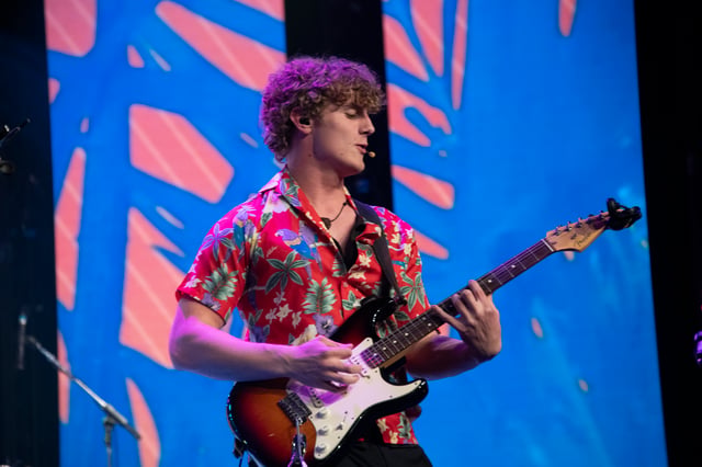 Orson Wright playing electric guitar in a Hawaiian shirt