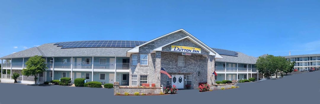 The full length of The Dutton Inn under a blue sky