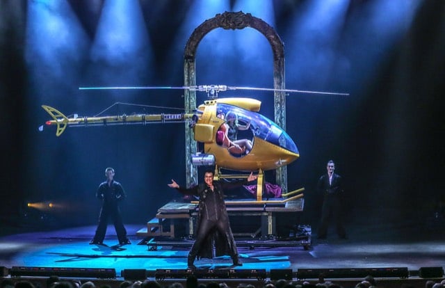 Rick Thomas on stage with a helicopter illusion