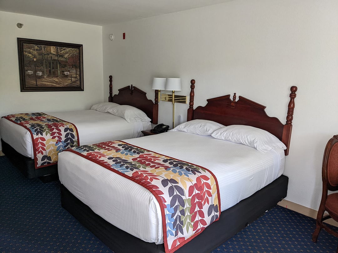 Double Queen room with two queen beds and carved headboards
