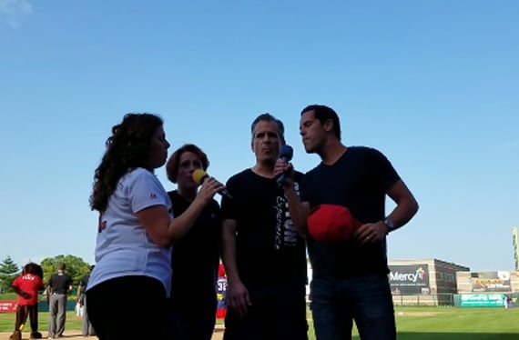 Duttons singing on the field at a baseball game