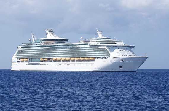 A cruise ship at sea under a blue sky