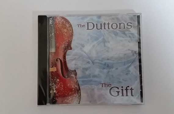 The Gift, The Duttons’ Christmas album, with a red violin on a frosted cover