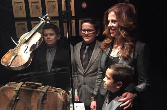 Amy Dutton and her sons beside a violin on display at the Titanic Museum
