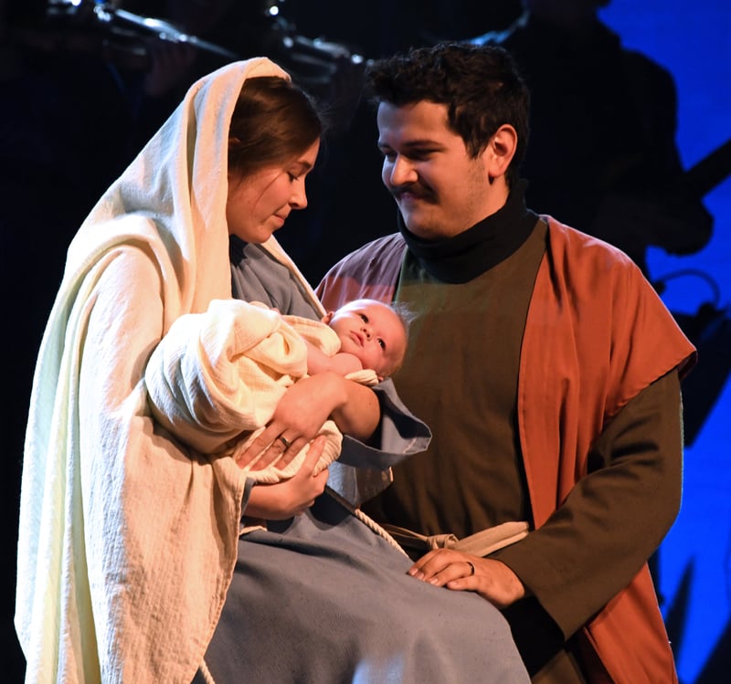 Mary and Joseph holding the baby Jesus in the nativity scene
