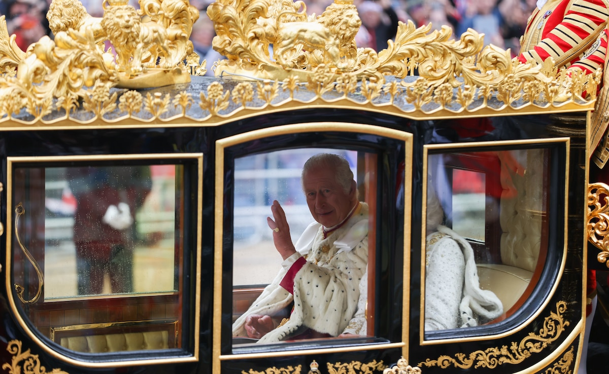 King Charles III waves from the Diamond Jubilee carriage, on the day of the coronation of King Charles III, in London, UK, on Saturday, May 6, 2023. The event is expected to put enduring British soft power on display as some 2,000 dignitaries, spiritual leaders and celebrities watch on, with thousands gathering on Londons streets and millions more tuning in from around the globe. Photographer: Hollie Adams/Bloomberg