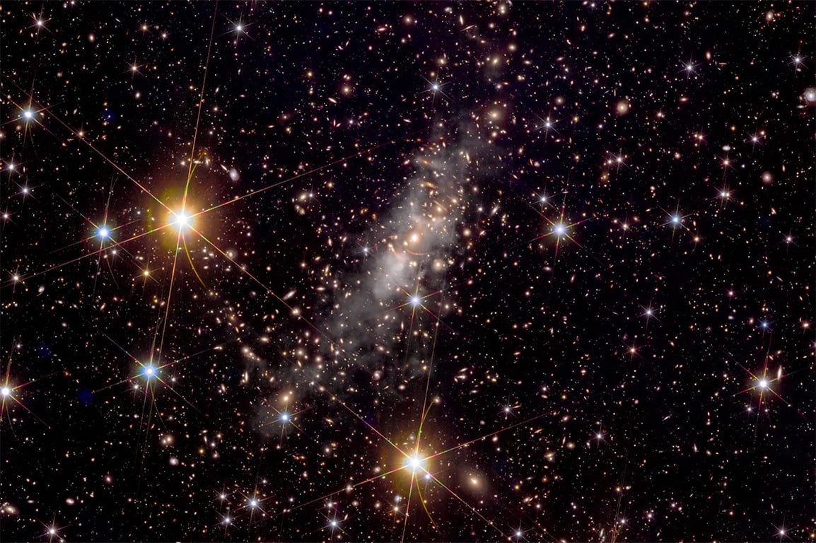 new image of galaxy cluster Abell 2390, a giant conglomeration of many galaxies like the Milky Way.