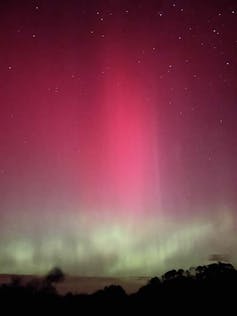 A colourful aurora in a dark night sky.