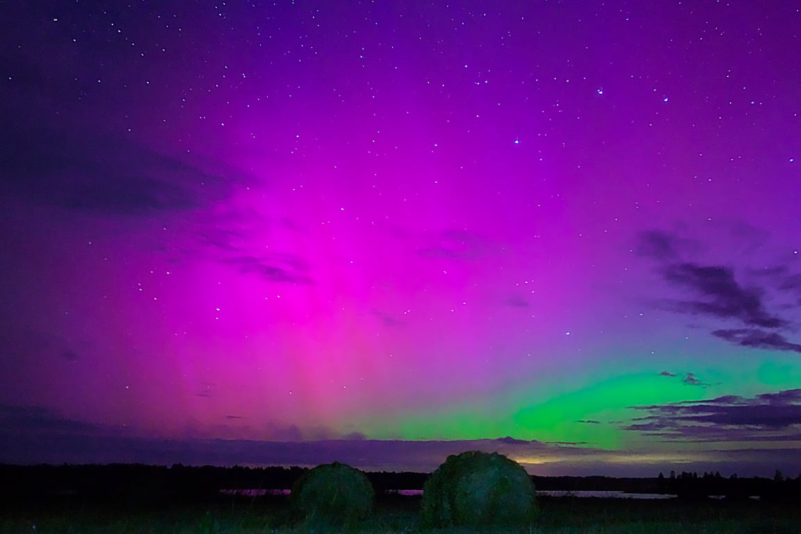 Рулоны соломы в поле освещаются северным сиянием. Чашникский район Витебской области, Беларусь. Фото Сергея Серебро