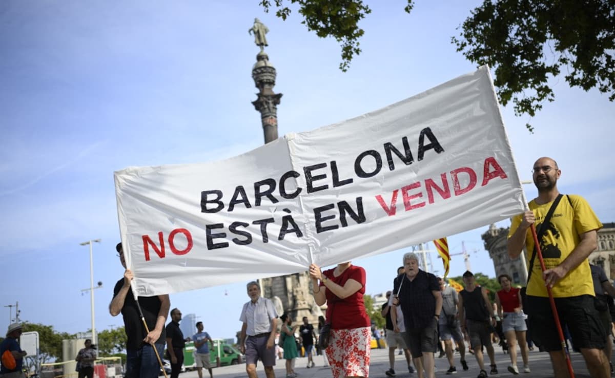 Demonstrators hold a sign reading Barcelona is not for sale during a protest against mass tourism in Barcelona