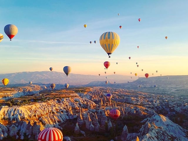 A view of Cappadocia with its fairy chimneys and hot air balloons