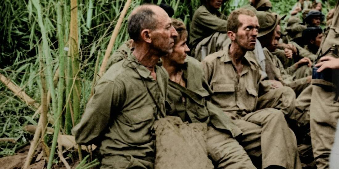 Soldats américains et philippins épuisés et amaigris assis dans la jungle pendant la marche de la mort de Bataan en 1942 aux Philippines.