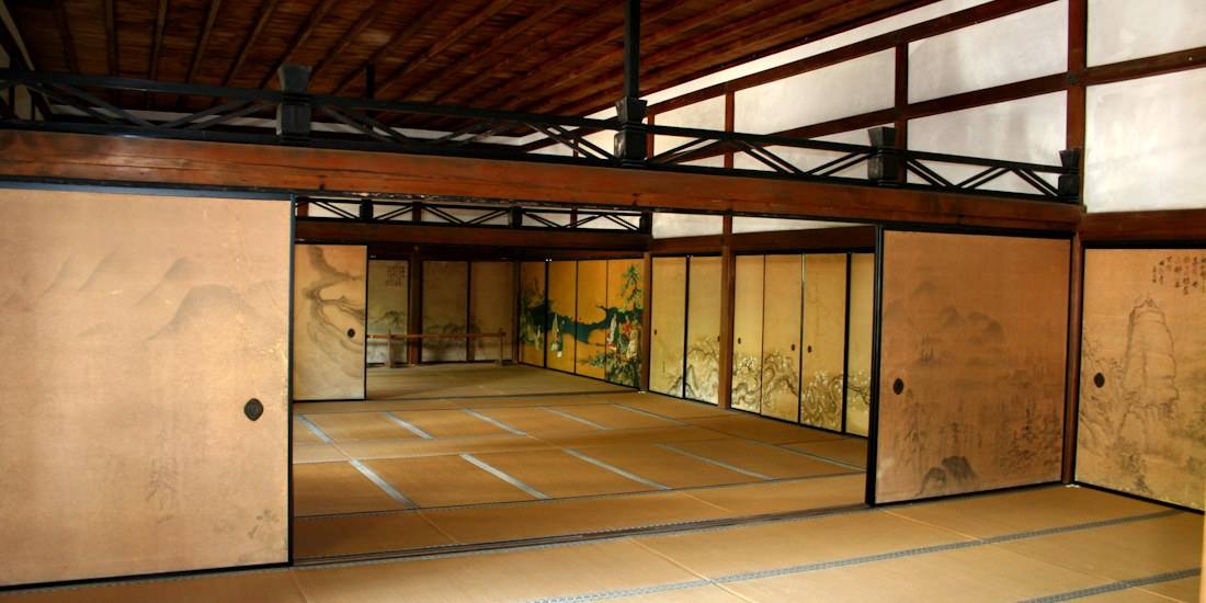 Intérieur du bâtiment Hojo au temple Ryoan-ji à Kyoto avec sols en tatami, cloisons coulissantes fusuma peintes et architecture japonaise traditionnelle en bois.