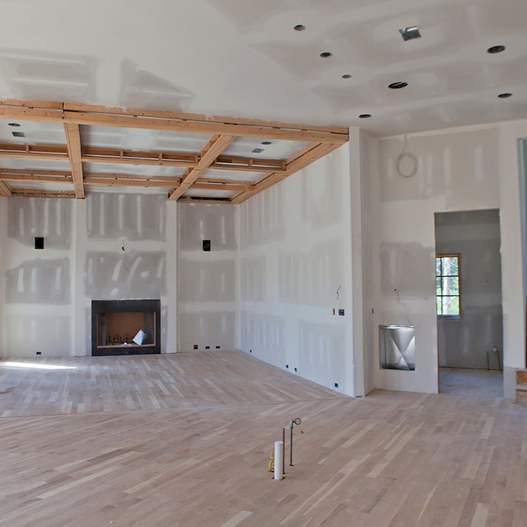 Great room at drywall stage with exposed ceiling beams