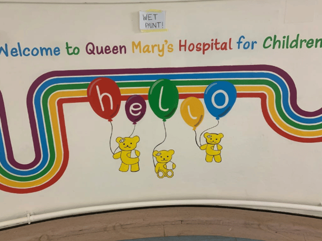 Final mural, showing a rainbow, teddy bears, balloons