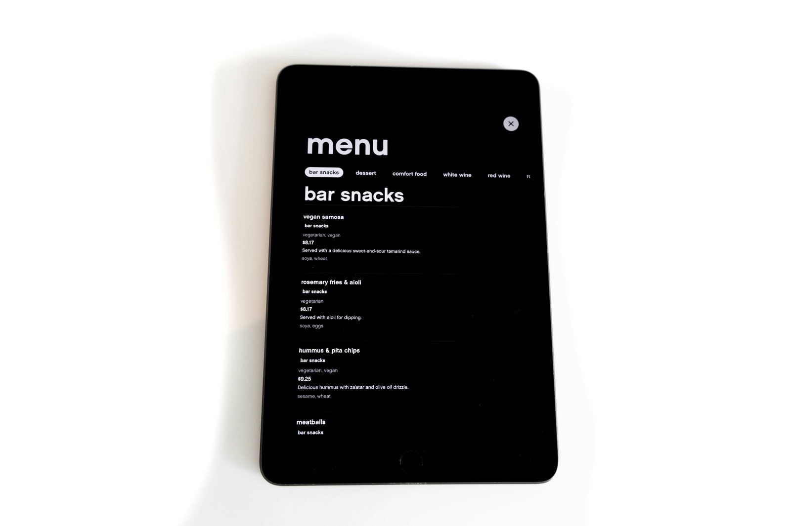 Delivery driver picking up takeout orders from a restaurant counter, showing how online ordering and delivery platforms integrate with restaurant operations.