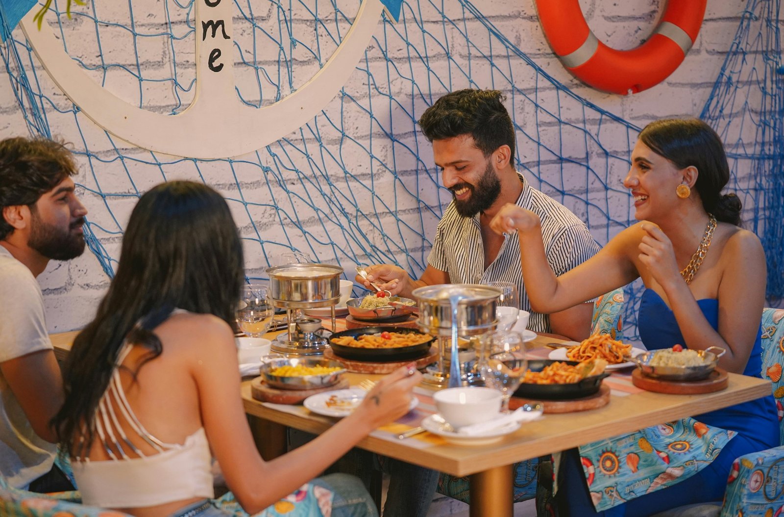 Group of guests enjoying a busy restaurant dinner service during peak hours