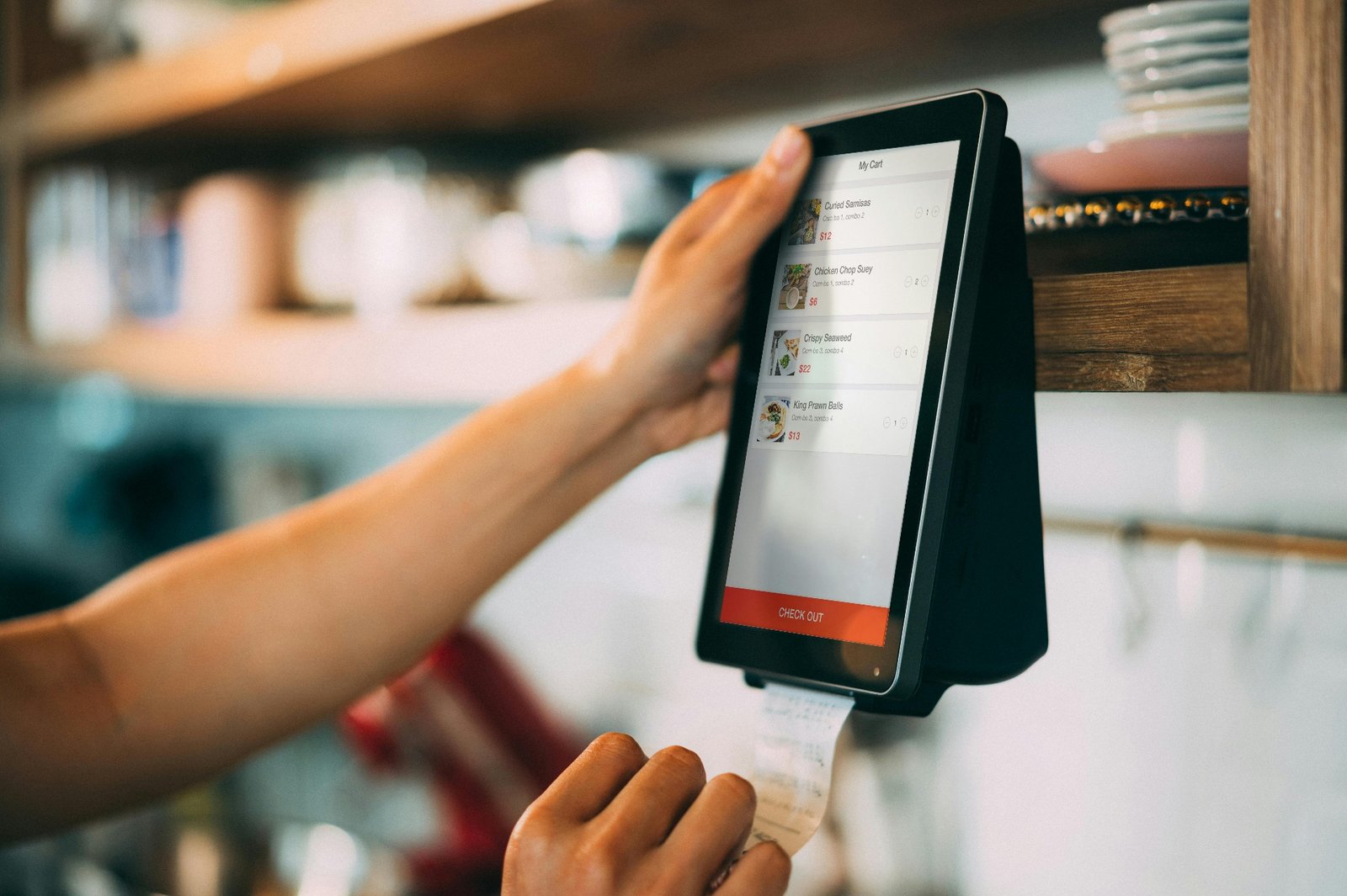 Server processing payment on a modern restaurant POS terminal