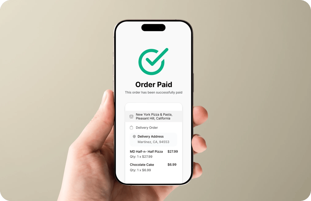 Hand holding a phone showing an order paid by card
