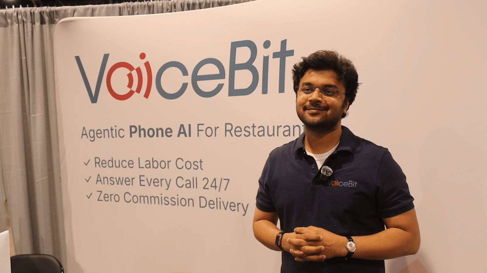 VoiceBit CEO Hitesh standing in front of the VoiceBit booth at the National Restaurant Association Show