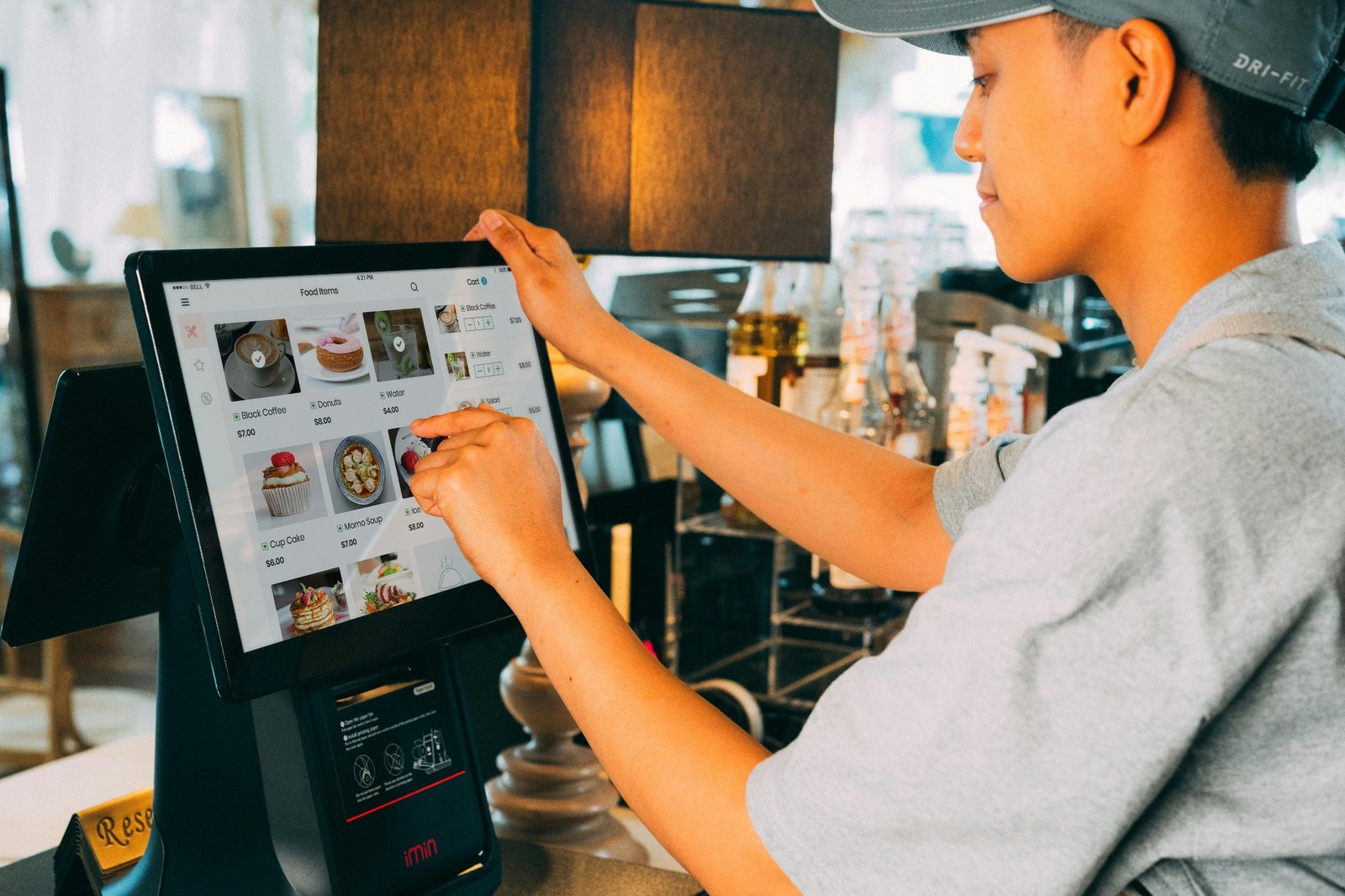Server using a touchscreen point-of-sale tablet to take orders