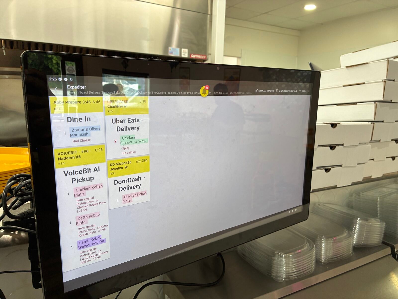 Toast Expediter screen on the line showing VoiceBit AI Pickup alongside Dine In and third-party tickets