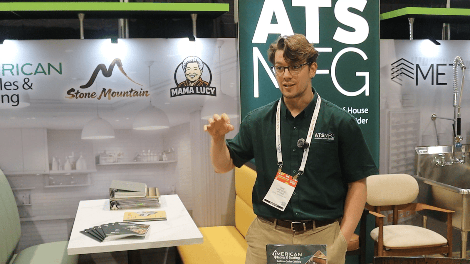 Isaac Wexel from ATS MFG speaking at the ATS MFG booth about restaurant furniture and hospitality