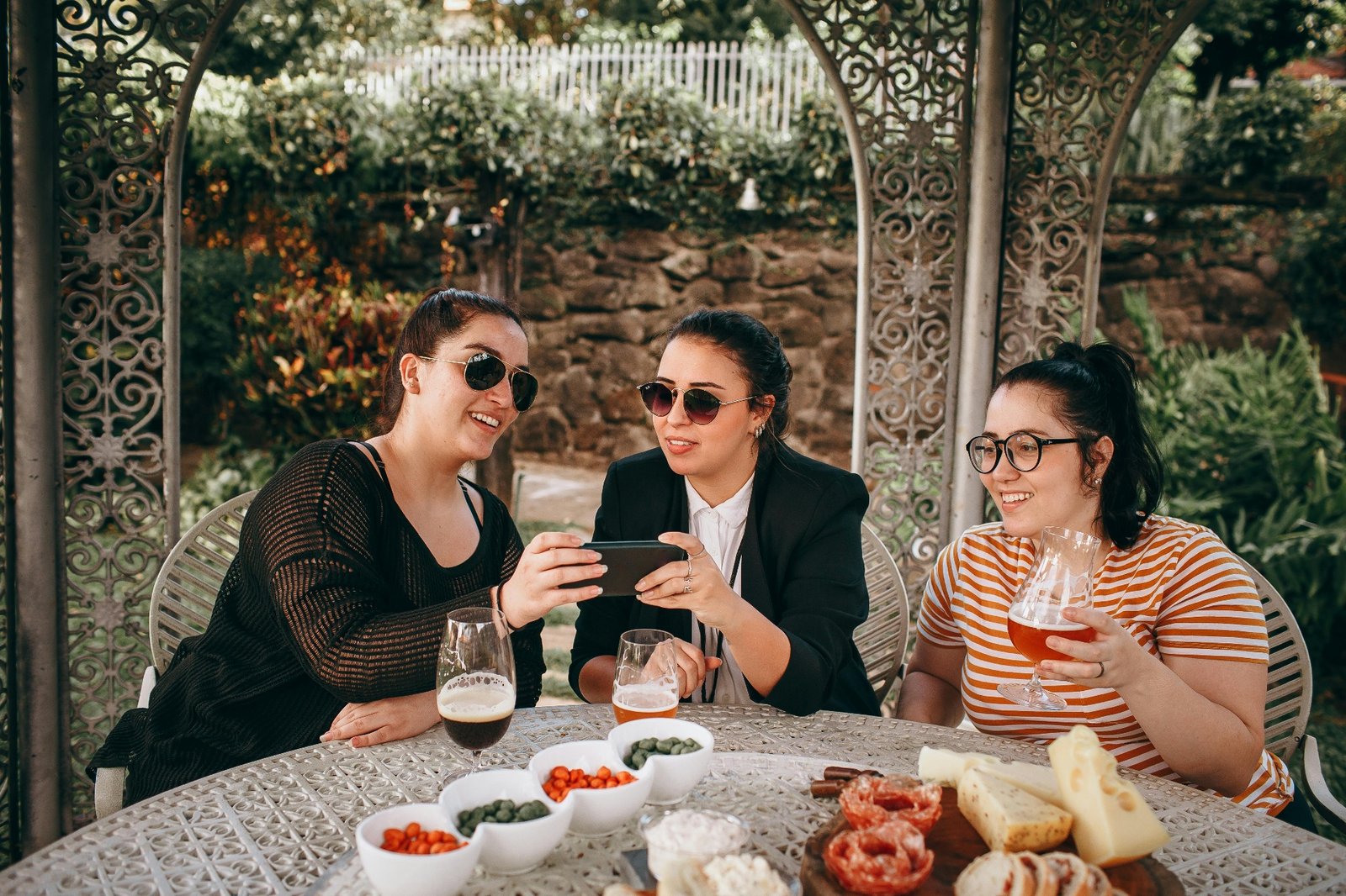 Happy restaurant guests sharing food and drinks on a sunny patio after a smooth, efficient service