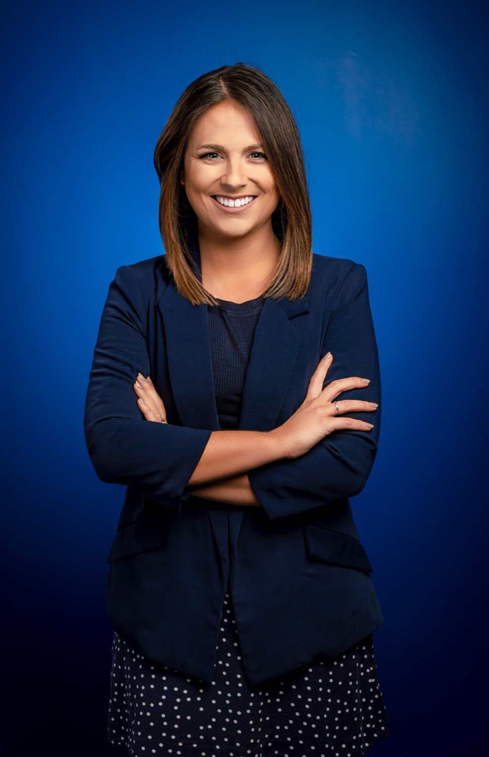 A smiling Springfield Clinic professional in a navy blazer