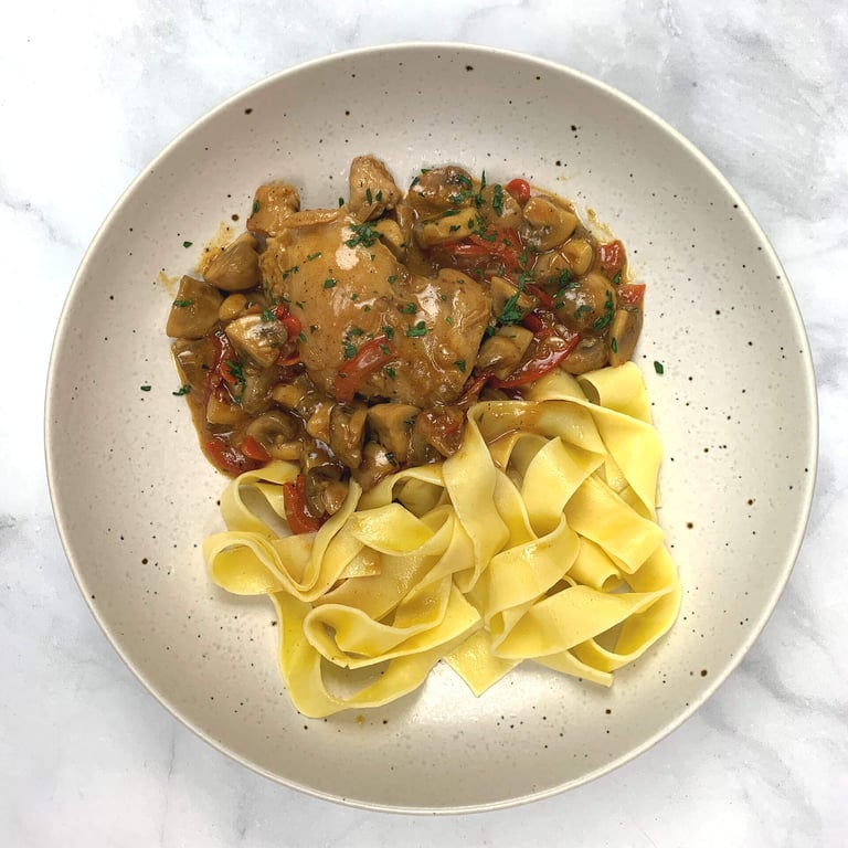 Chicken Stroganoff with pasta on plate.