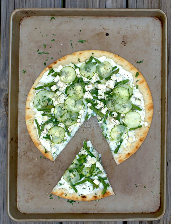 Top down picture of Green Garden Pizza with Ricotta and Tofu, with cut out wedge