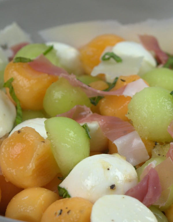 Close up picture of melon, cantaloupe, mozzarella and prosiutto