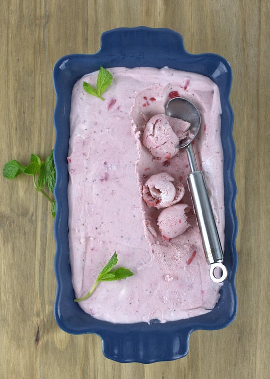 Big blue dish with No-Churn Strawberry Ice Cream and ice scoop