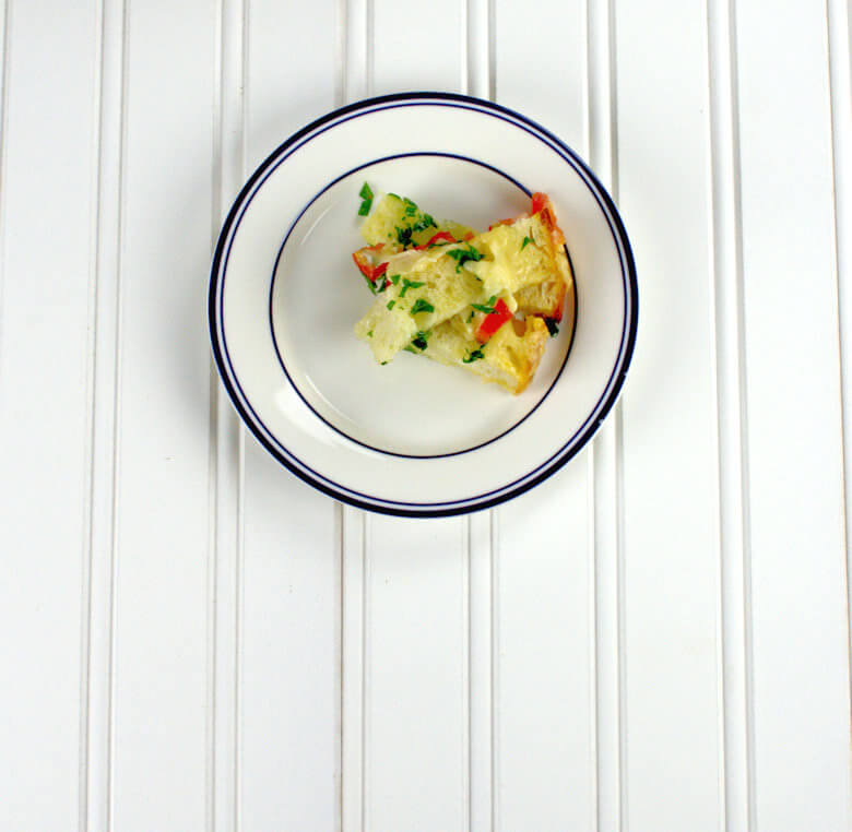 Picture of a piece of bread pulled away from the loaf, on a plate