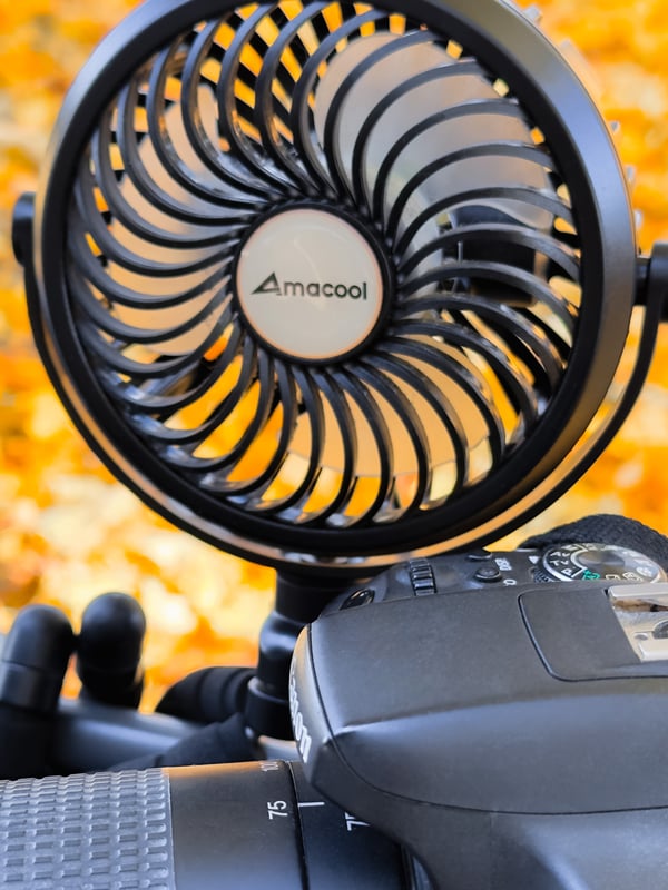 Close up of a mini portable fan and camera.