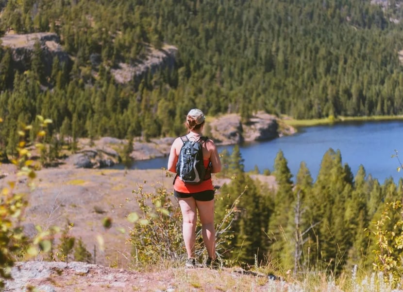 Woman stands in the hills overlooking Rose Valley